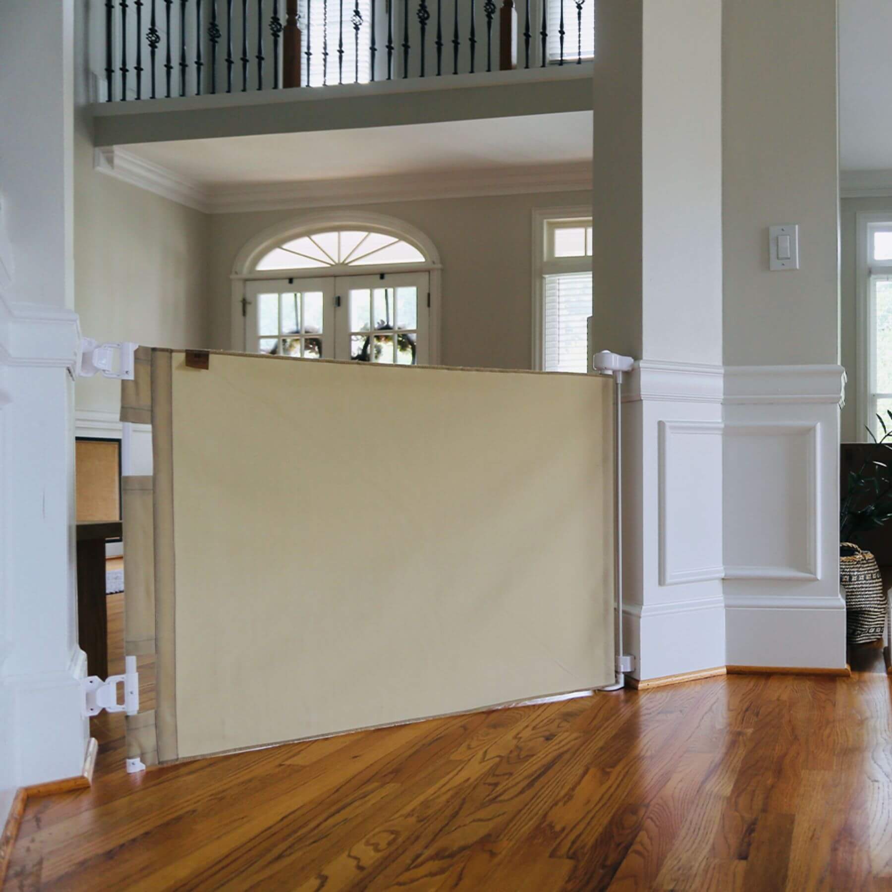 Room divider in a home interior with Crafted Gates Co. Oil Waxed Canvas Pet Safety Gate - Tan and white walls.