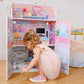 Girl Playing with Olivia's Little World Dreamland Glass-Look Dollhouse