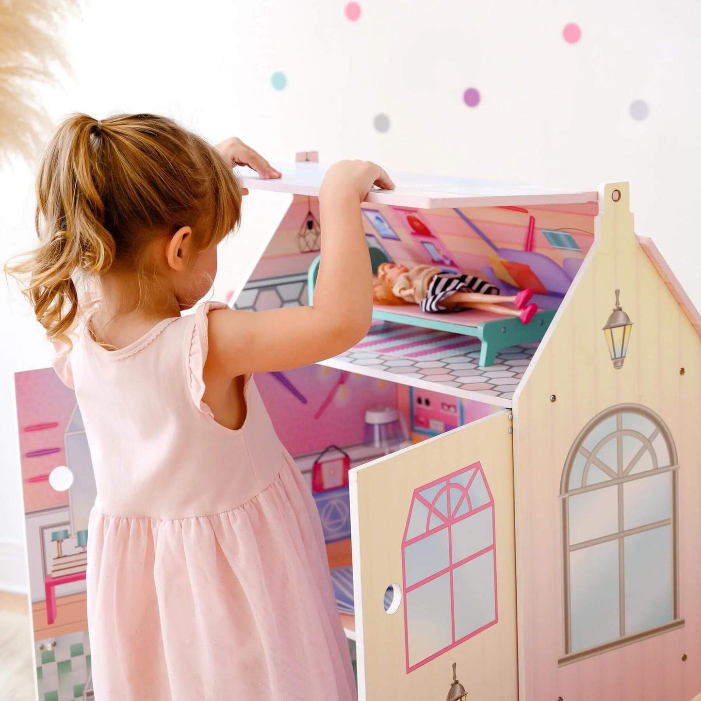 Girl Playing with Olivia's Little World Dreamland Glass-Look Dollhouse