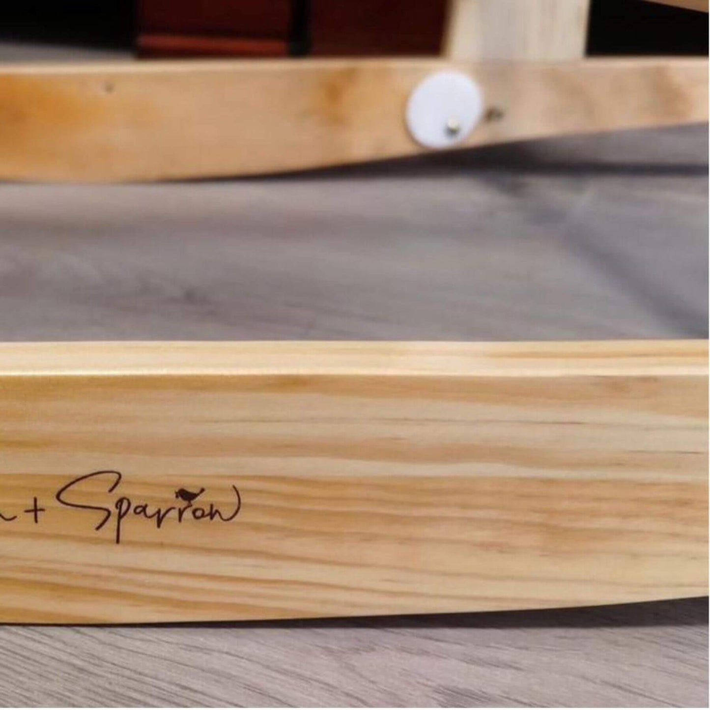 Wooden product with 'Sparran' branding on a gray surface