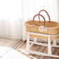 Wicker Moses basket on Plum+Sparrow Original Rocking Moses Bassinet Stand with brake White with light-colored floor and walls.