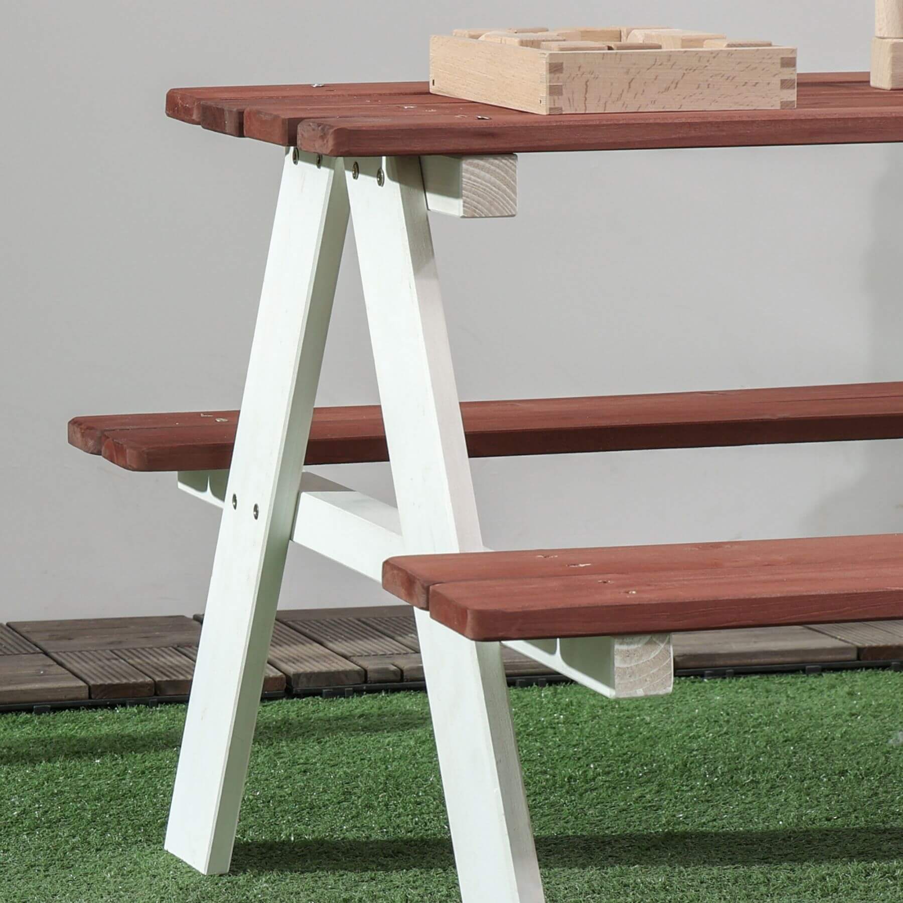 Wooden picnic table with benches on a grassy area