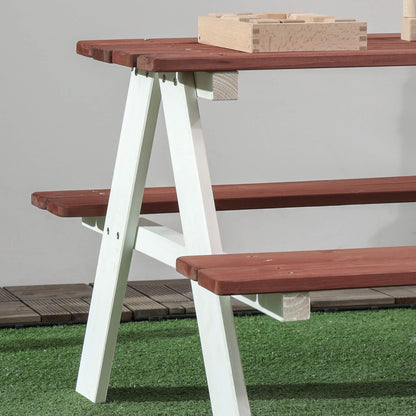Wooden picnic table with benches on a grassy area