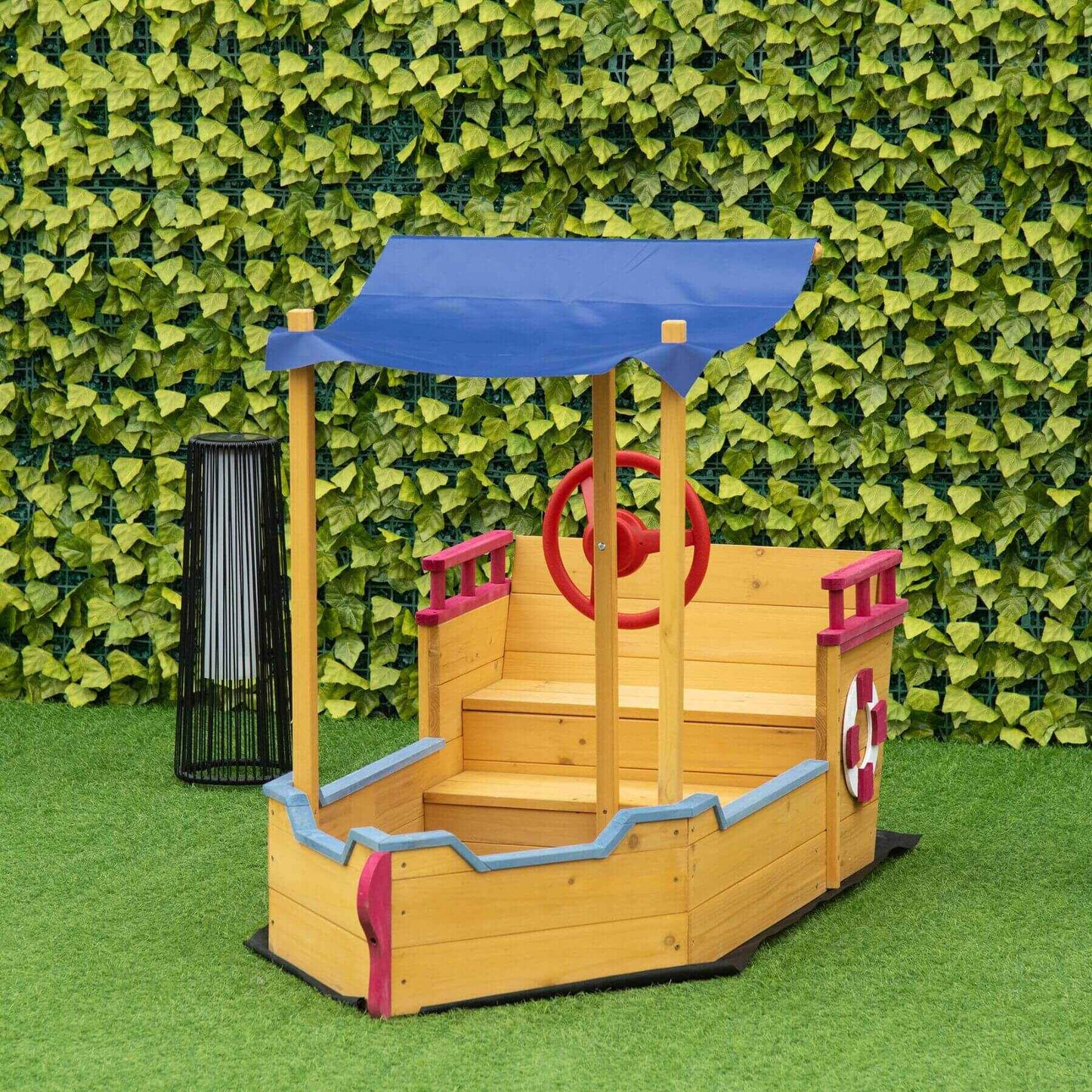 Outsunny Pirate Ship Sandbox - Orange against a green leafy background