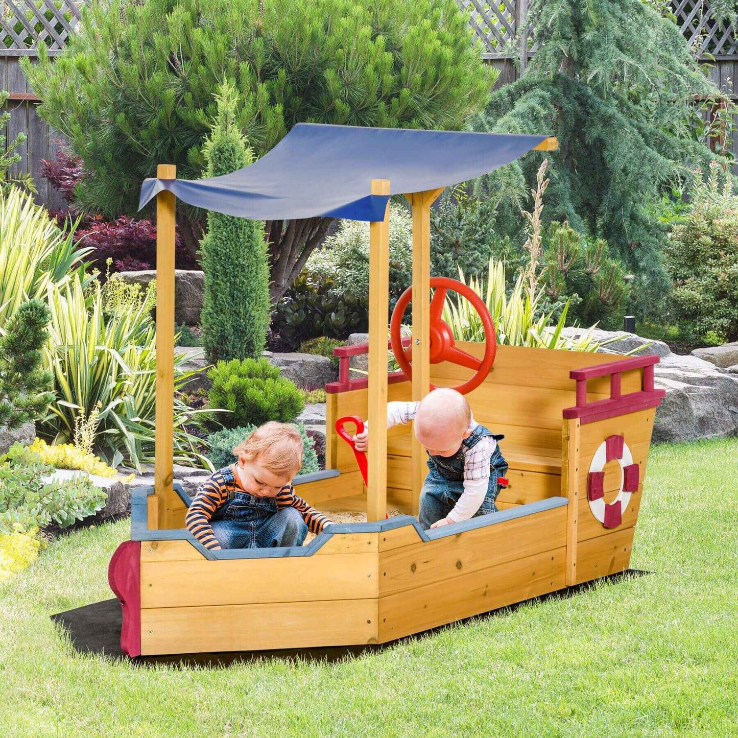 Outsunny Pirate Ship Sandbox - Orange in a garden setting.