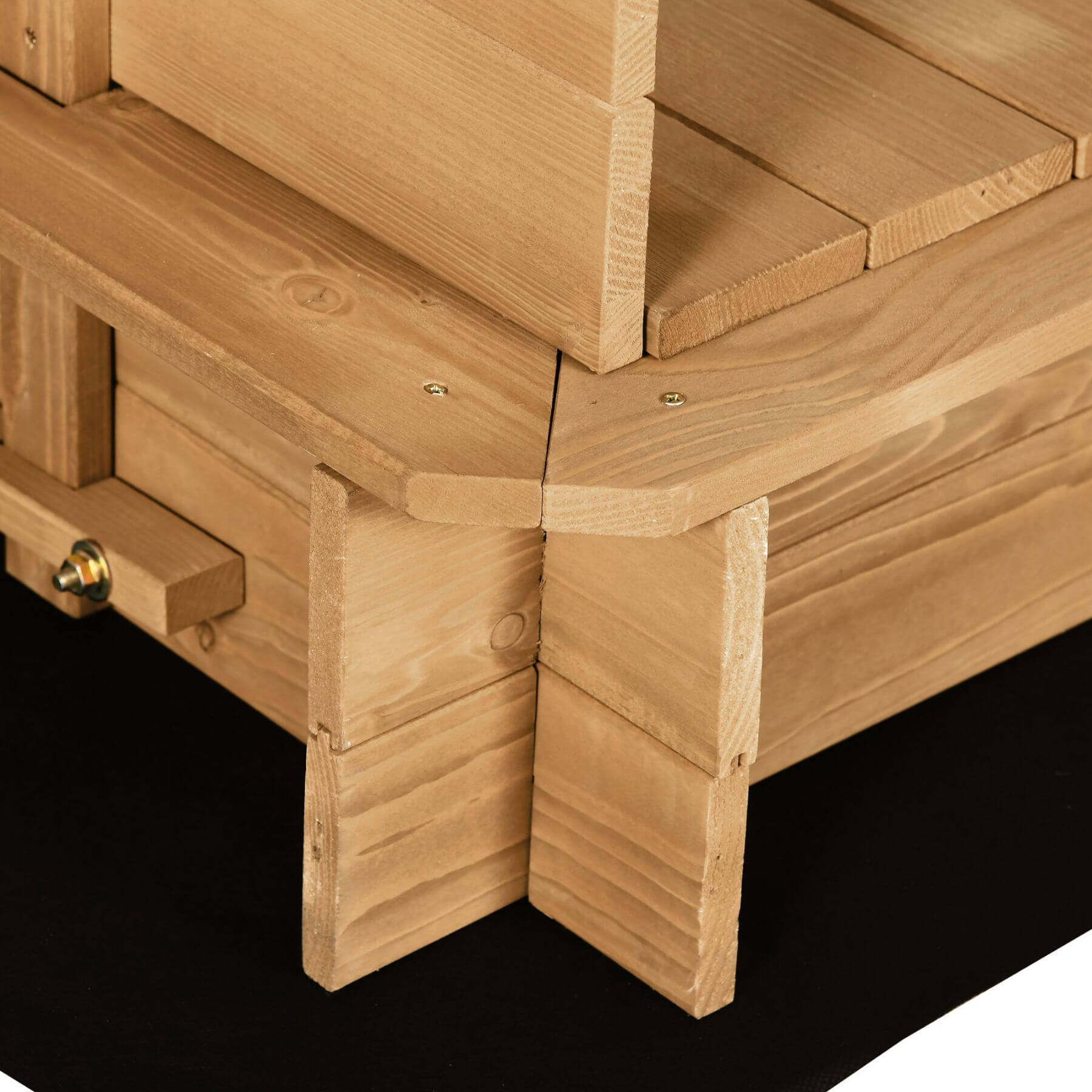 Close-up of a wooden bench with visible grain and construction details on a black background
