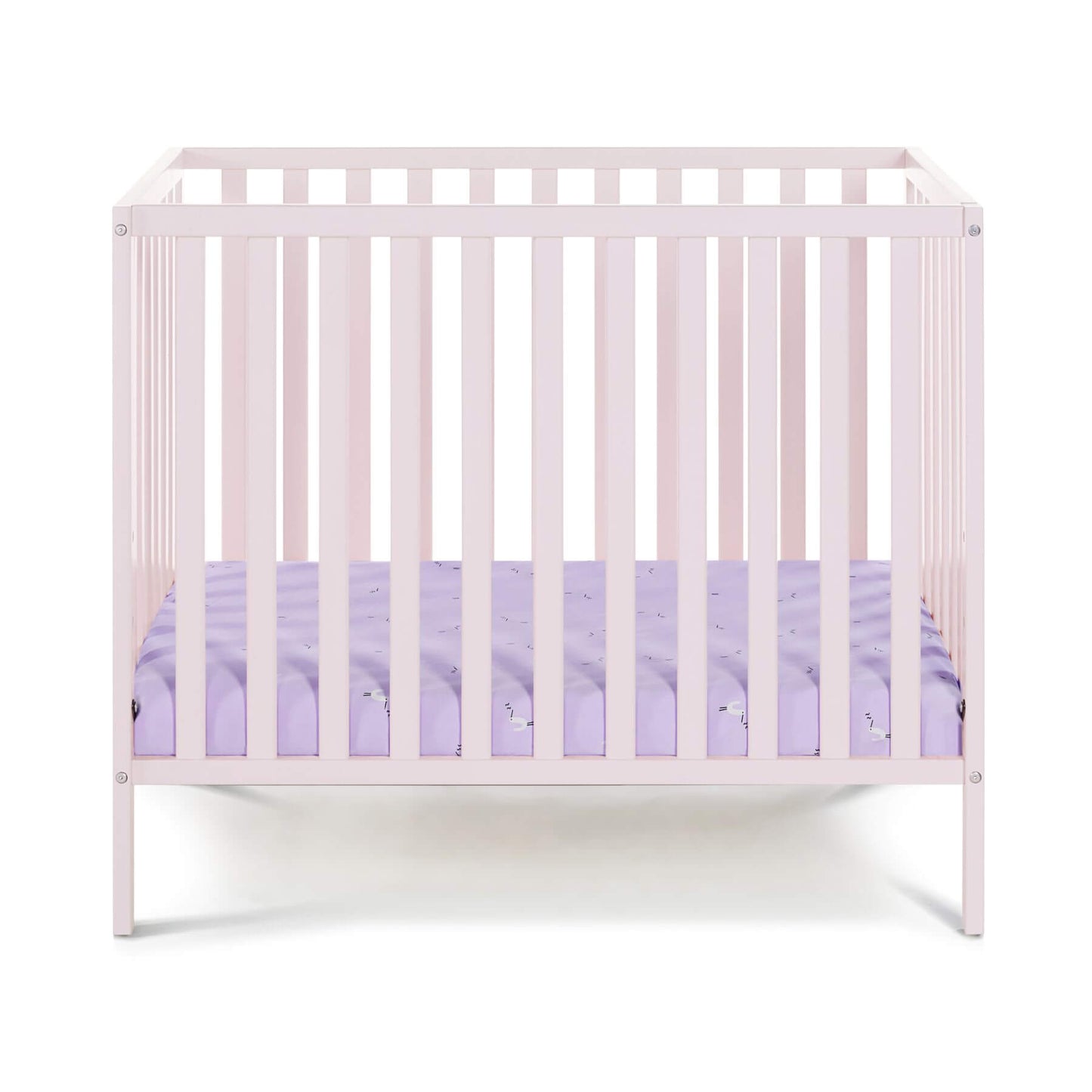 Palmer 3-in-1 Convertible Mini Crib Pastel Pink with a purple mattress on a white background