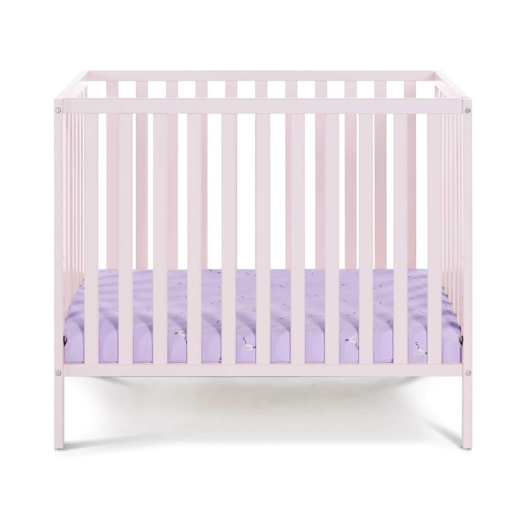 Palmer 3-in-1 Convertible Mini Crib Pastel Pink with a purple mattress on a white background