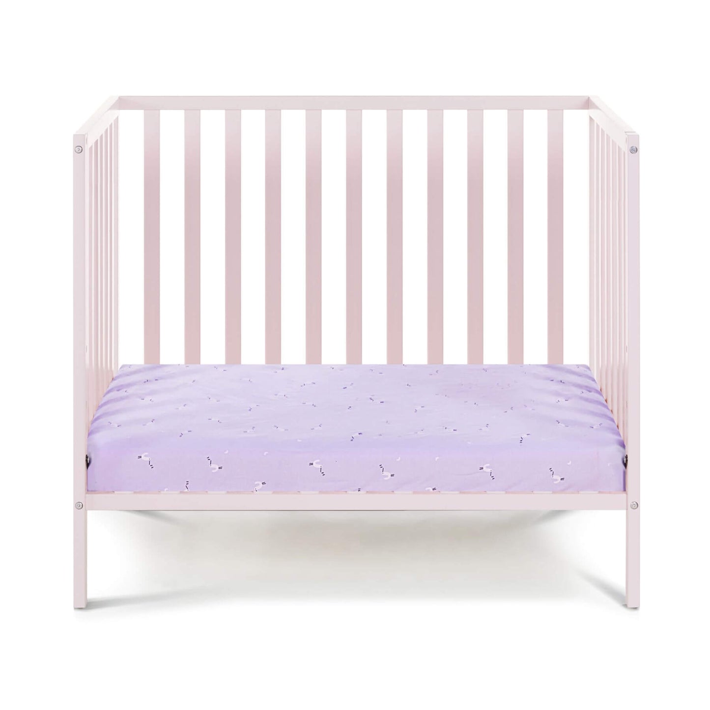 Pink crib with a purple mattress on a white background