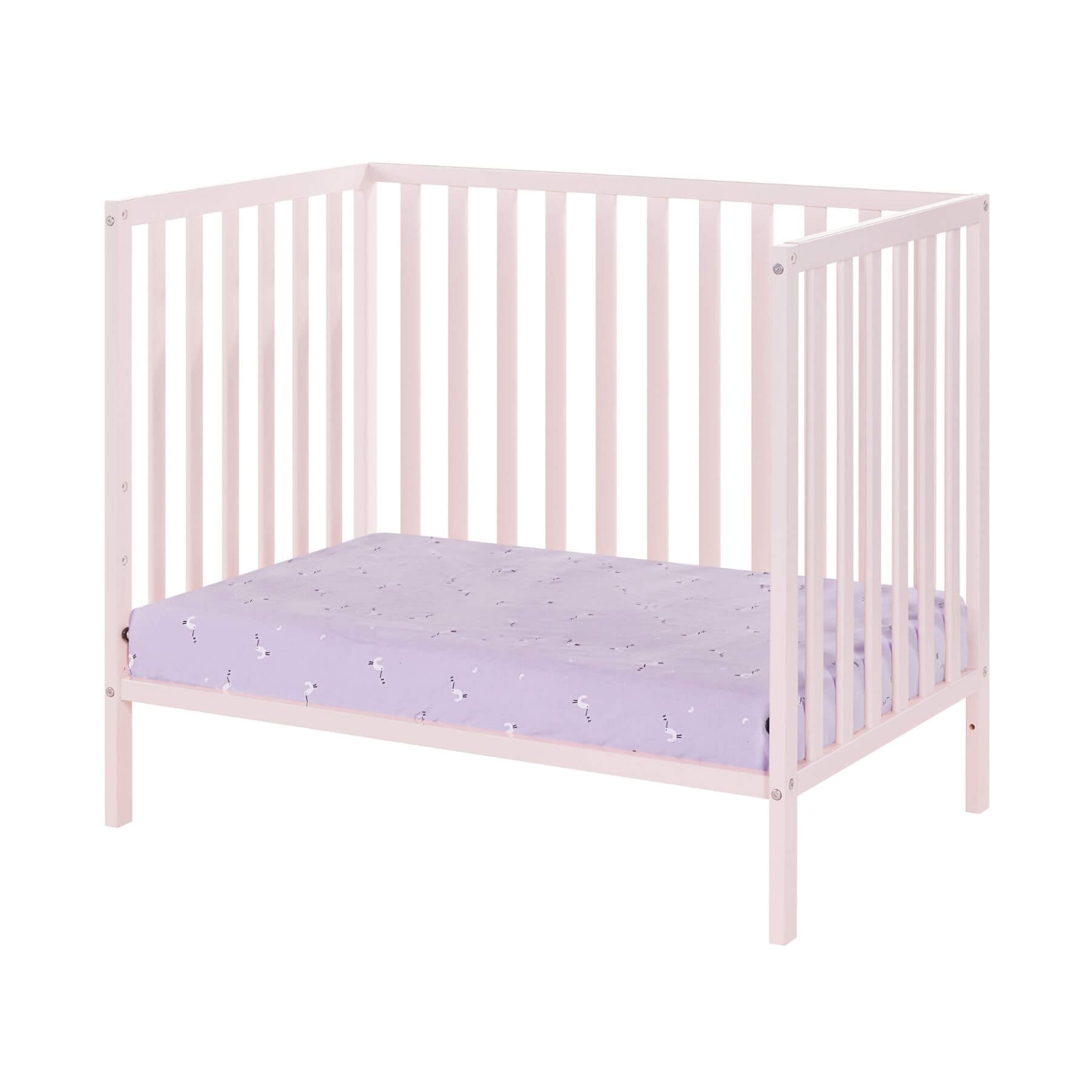 Pink crib with a purple mattress on a white background