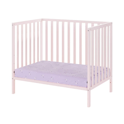 Pink crib with a purple mattress on a white background