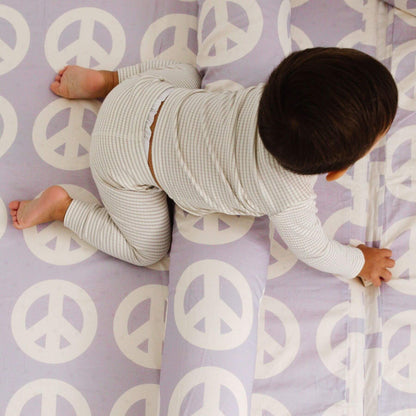 Child crawling on Toki Kids Peace Sign Organic Cotton Mat