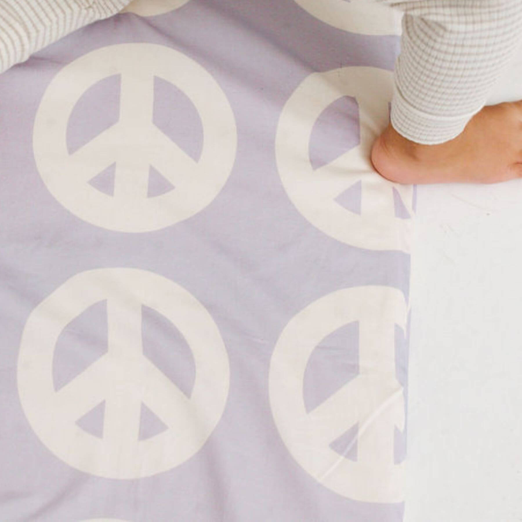 Close-up of Toki Kids Peace Sign Organic Cotton Mat