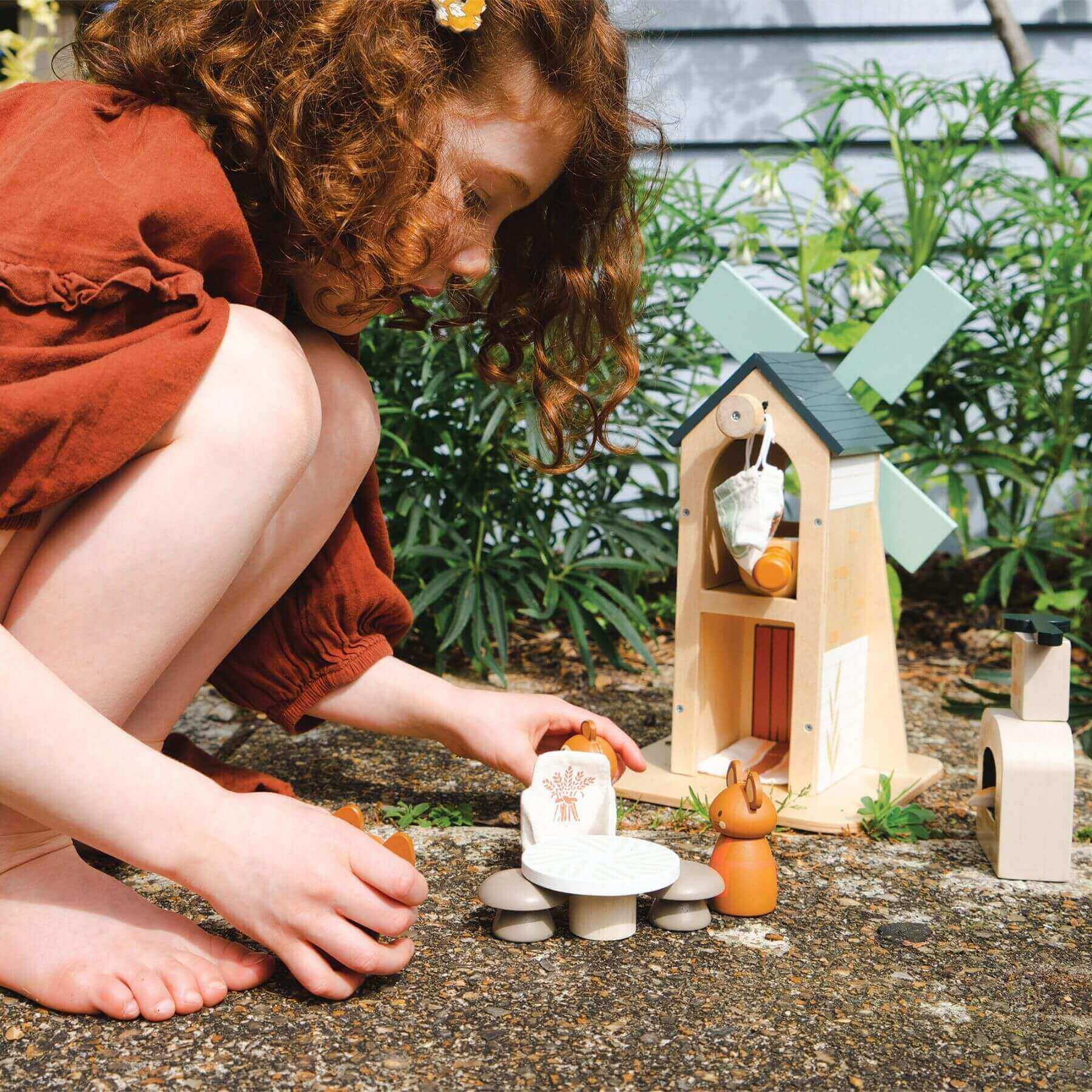 Child playing with Tender Leaf Penny Windmill