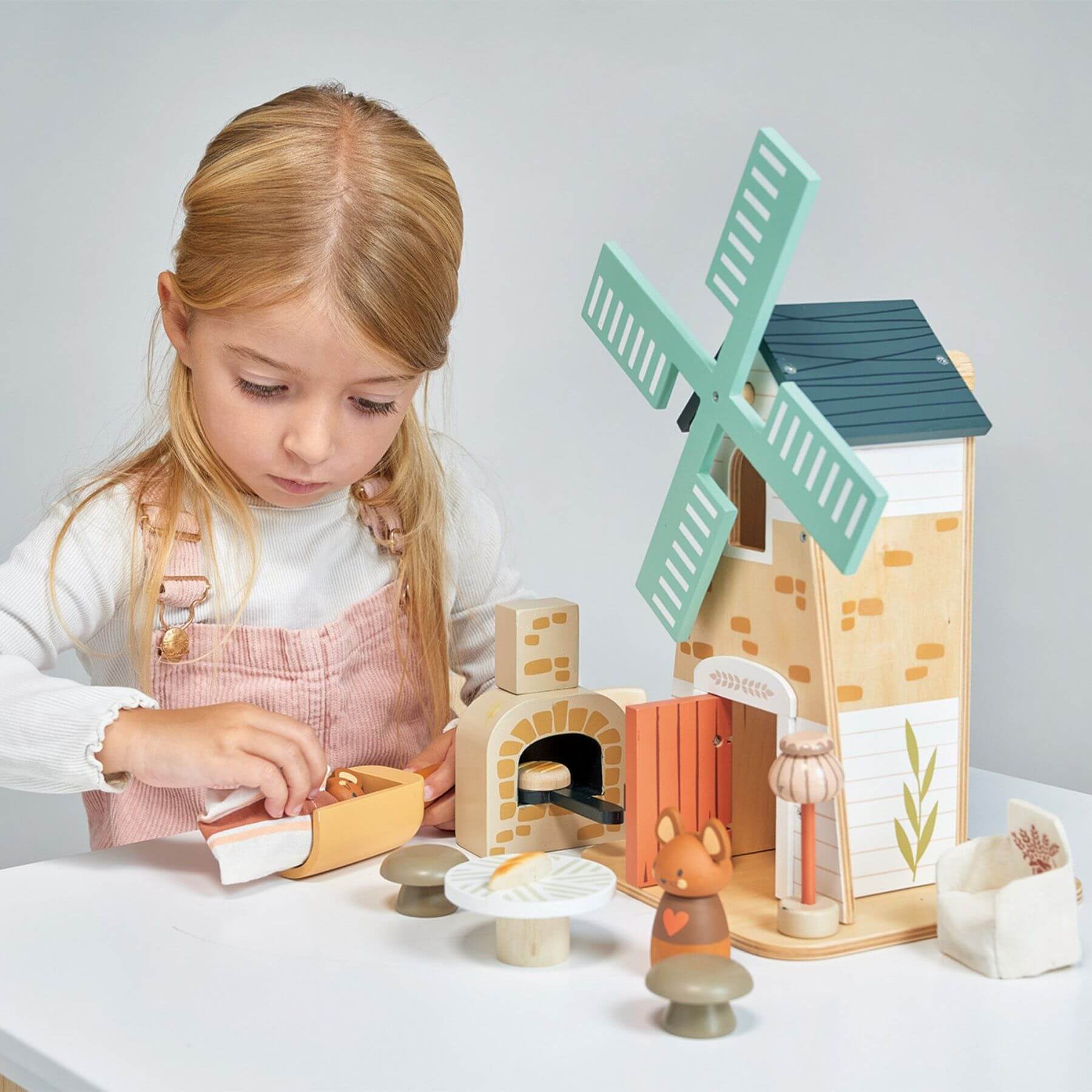 Child playing with Tender Leaf Penny Windmill