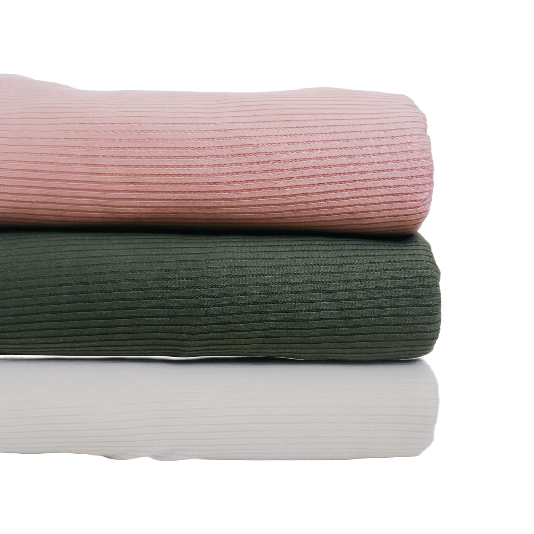 Stack of three Little Mae & Co Toddler Blanket in pink, green, and white on a white background