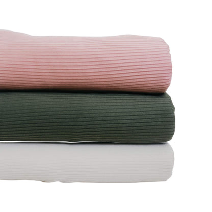 Stack of three Little Mae & Co Toddler Blanket in pink, green, and white on a white background