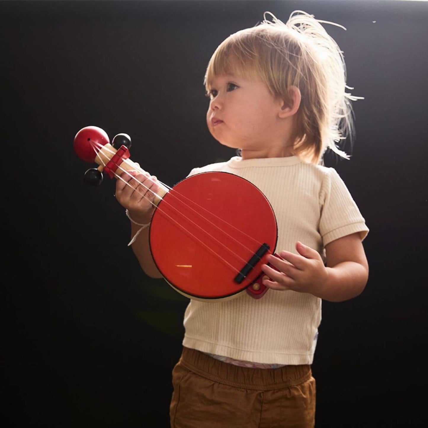 Boy Playing PlanToys Banjo