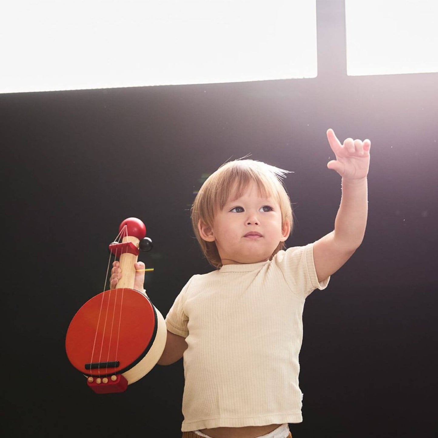 Boy Holding PlanToys Banjo