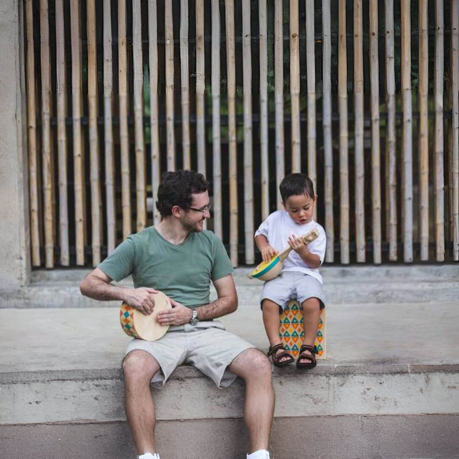 Man and Boy Playing PlanToys Banjolele