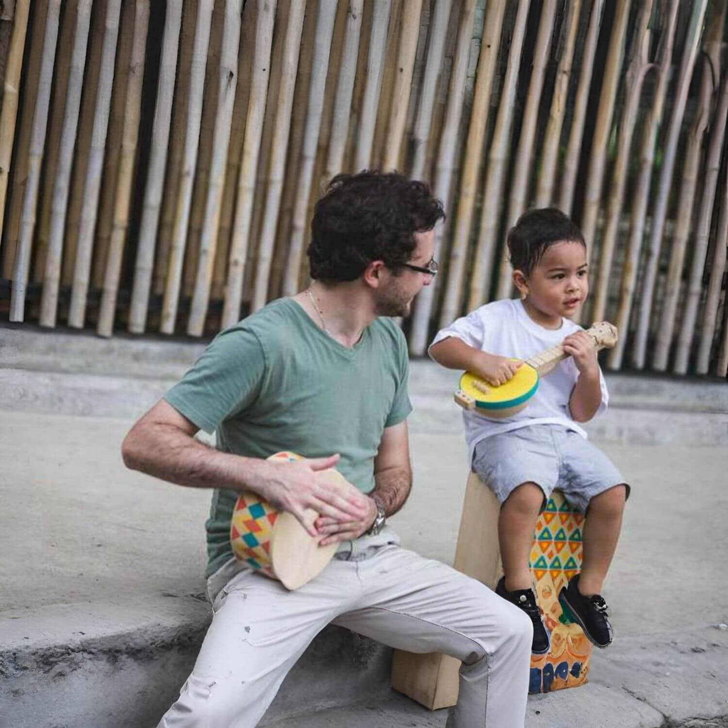 Man and Boy Playing PlanToys Banjolele