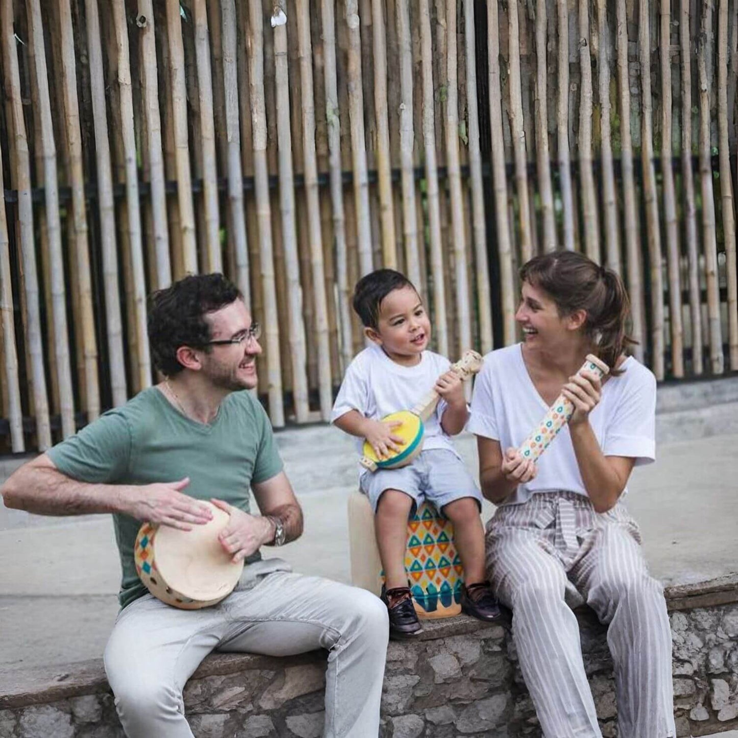 Parents and Kid Playing PlanToys Banjolele