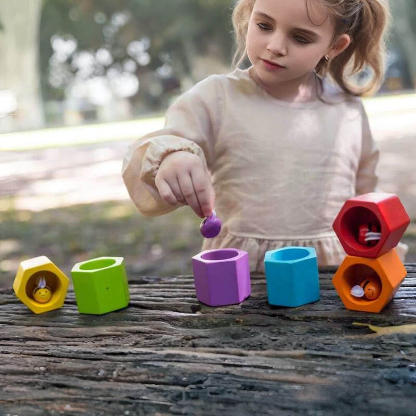 Girl Playing PlanToys Beehives