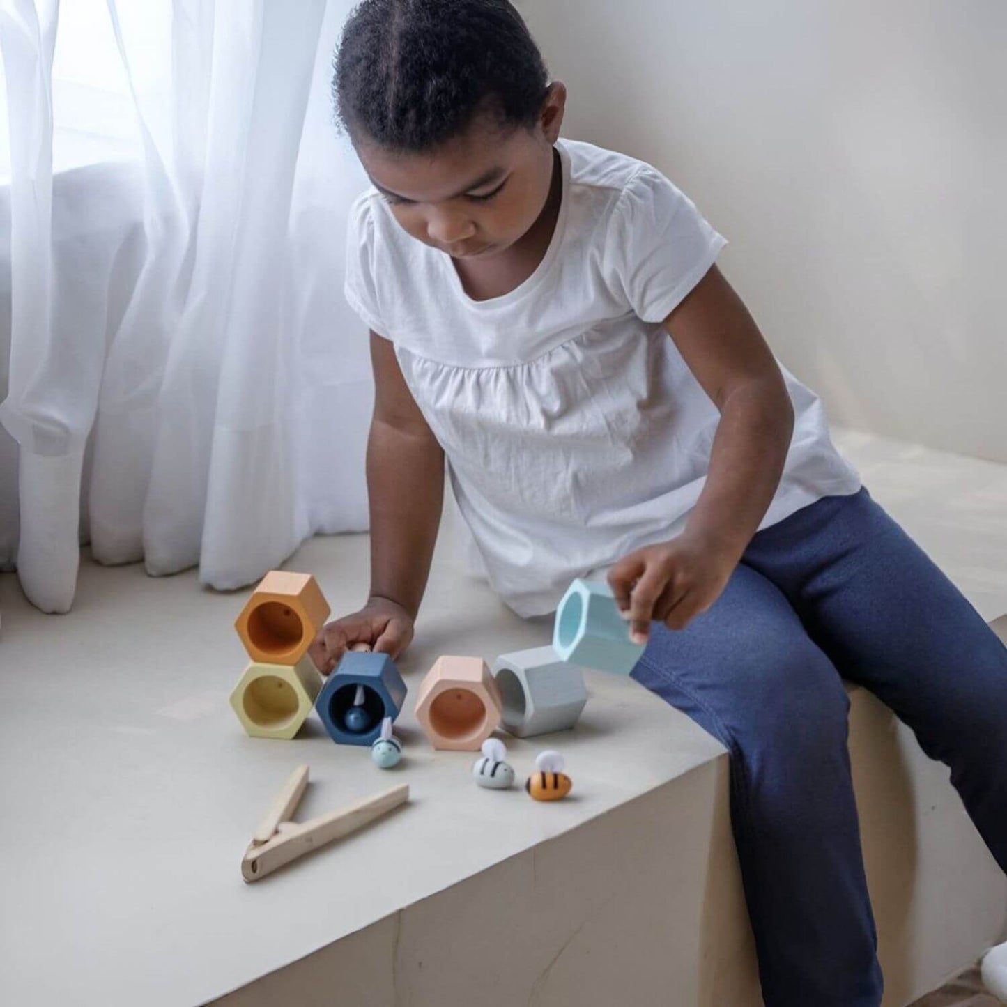 Girl Playing PlanToys Beehives - Orchard