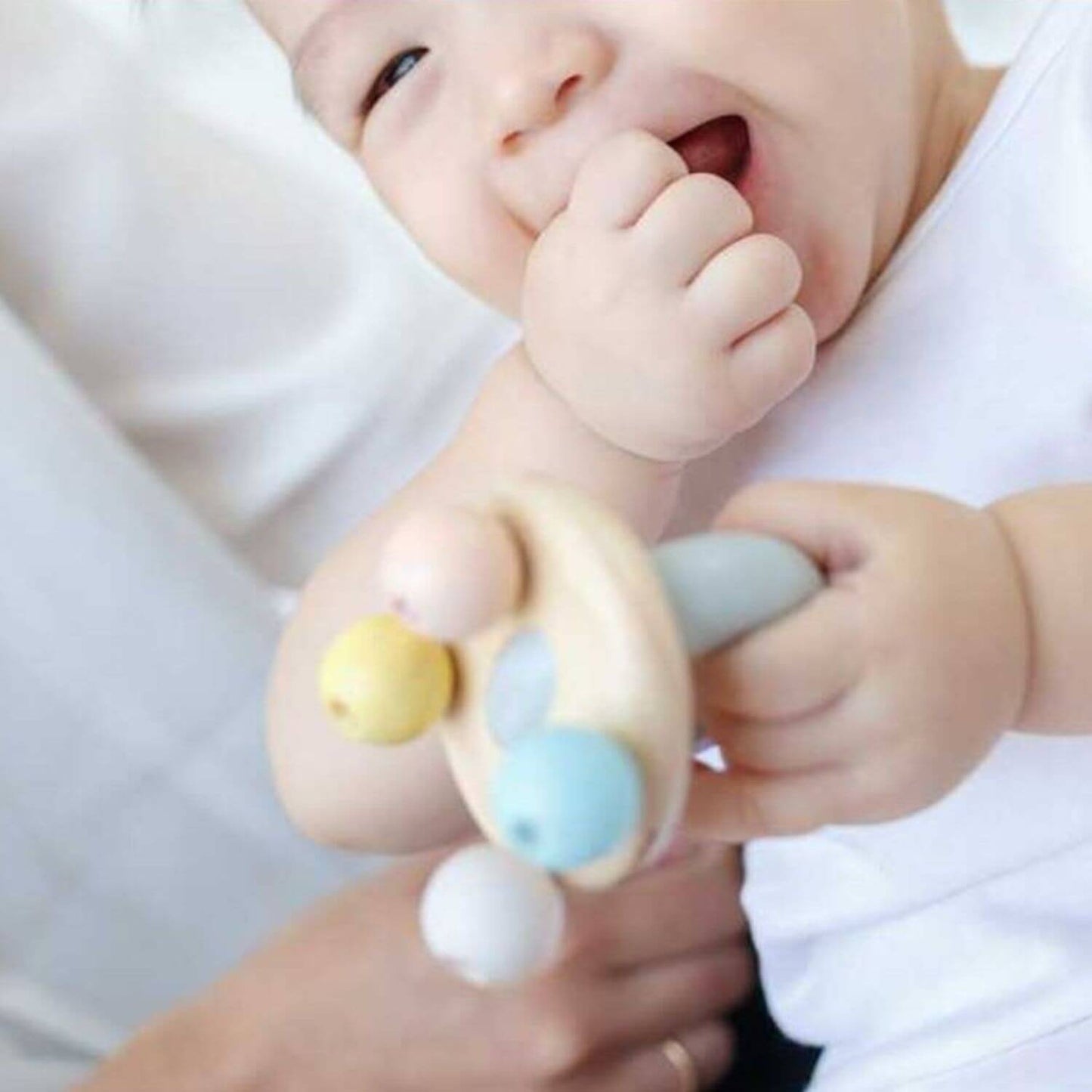 Baby Playing PlanToys Bell Rattle