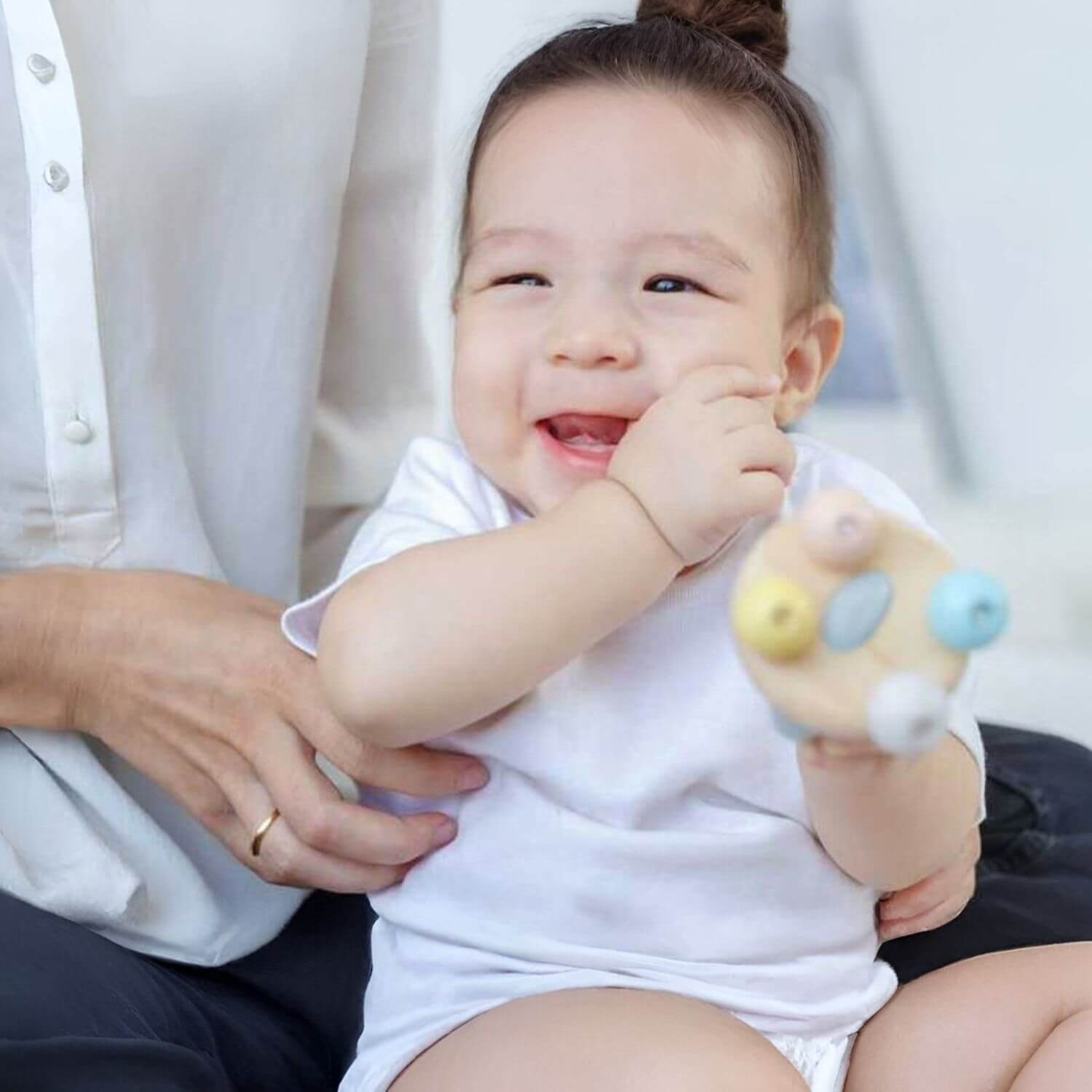 Baby Playing PlanToys Bell Rattle