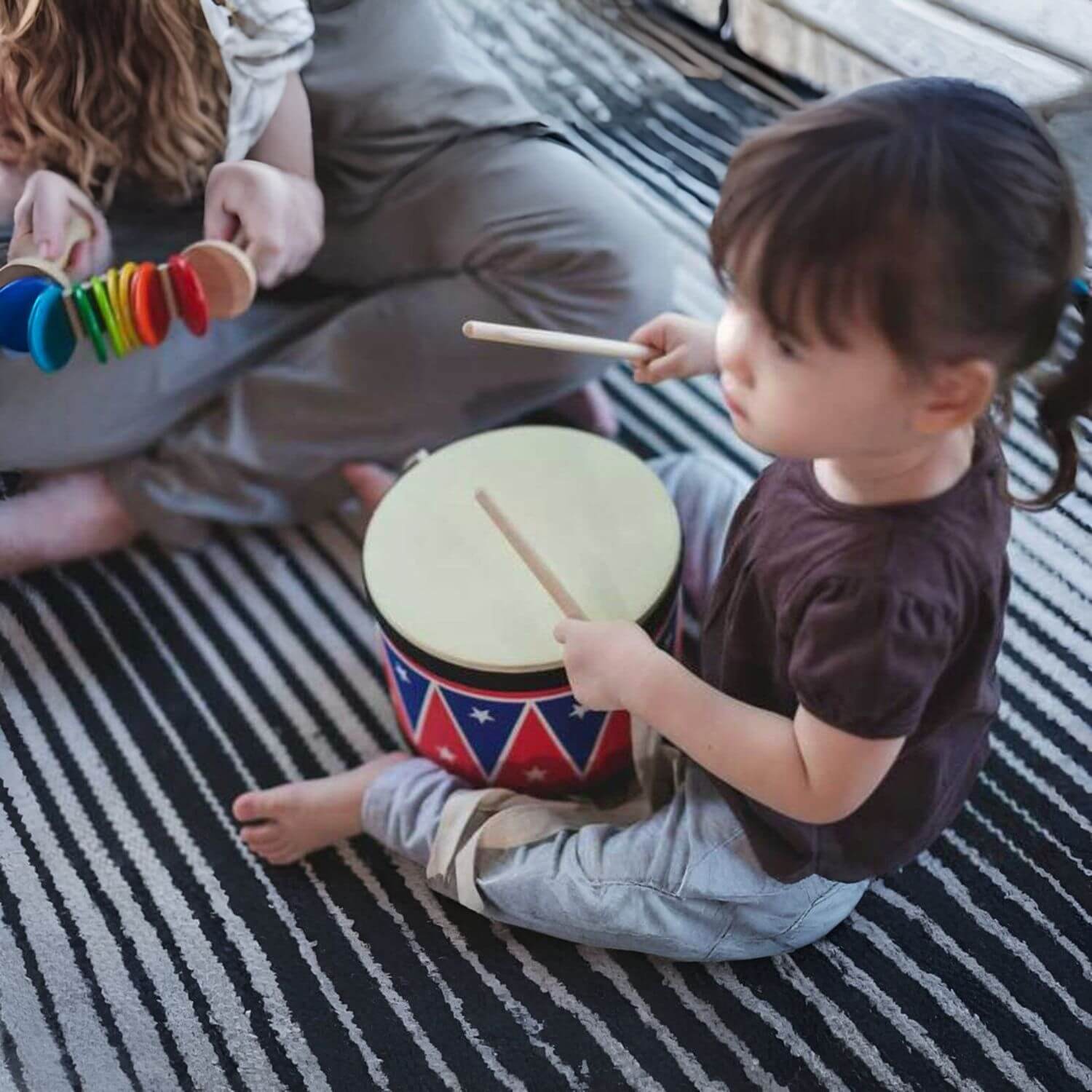 Girl Playing PlanToys Big Drum II