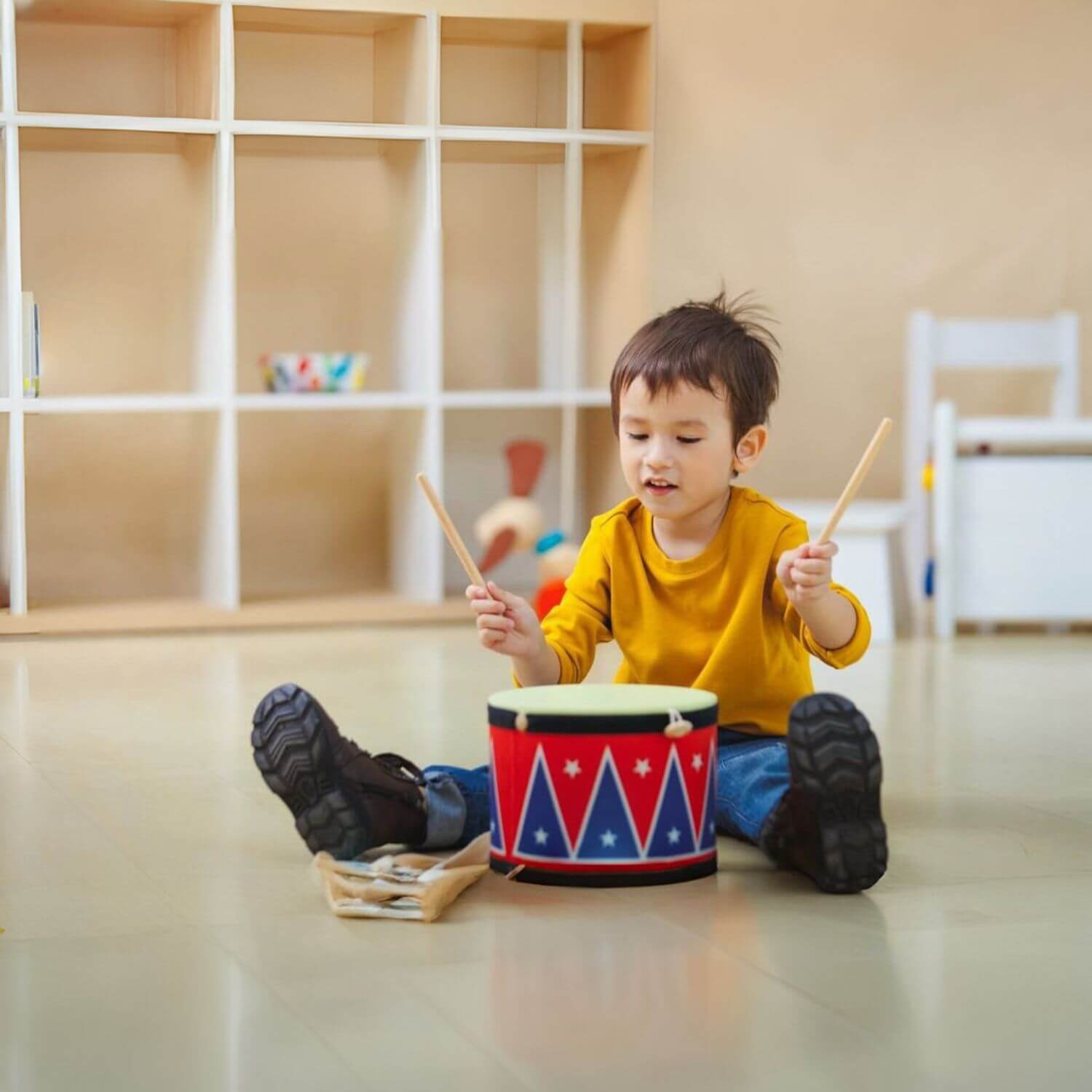 Boy Playing PlanToys Big Drum II