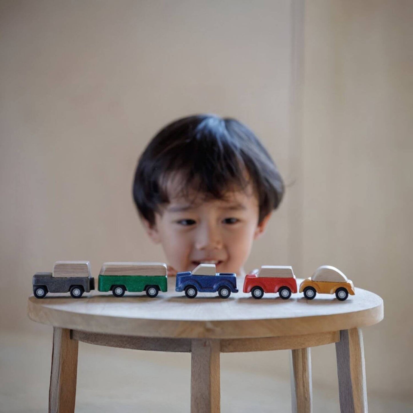 Boy Playing PlanToys Blue Truck