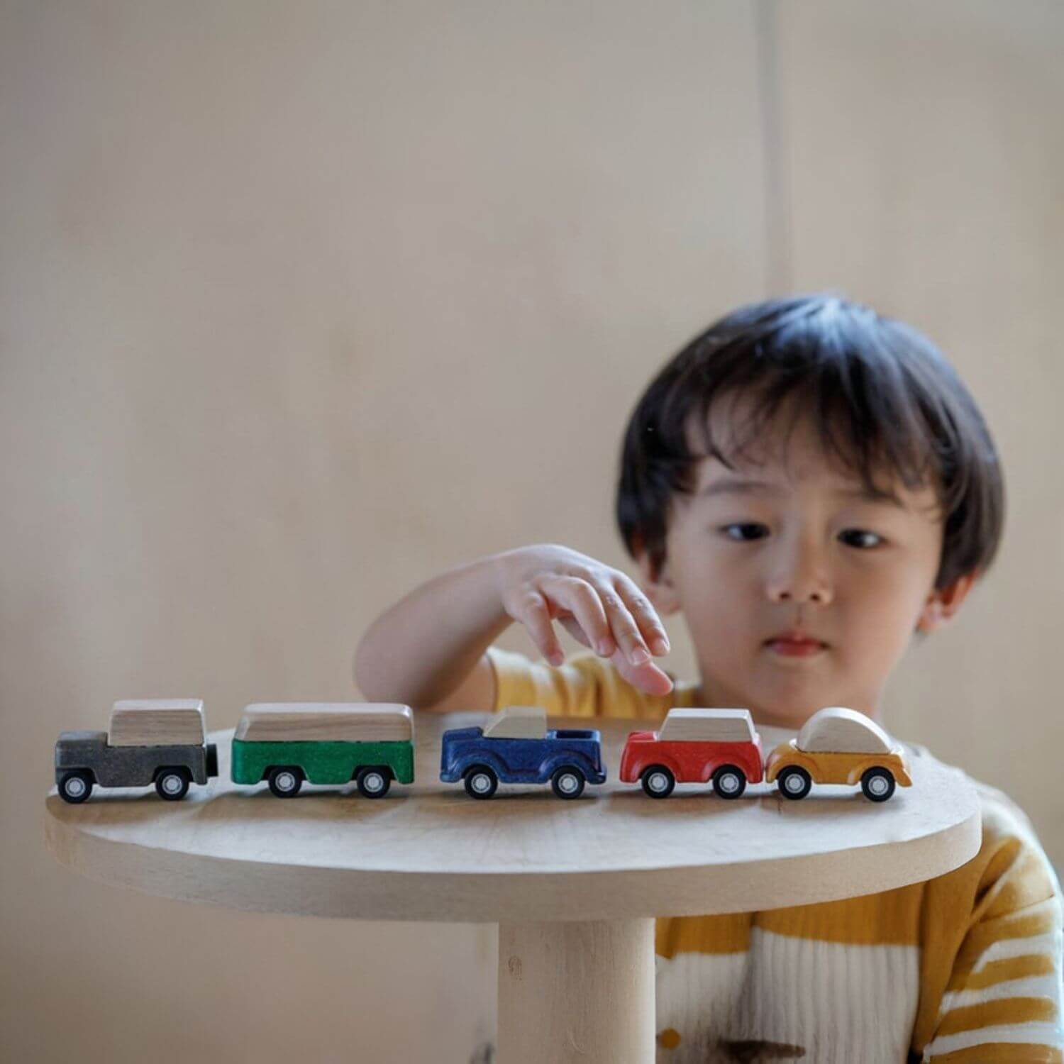 Boy Playing PlanToys Blue Truck