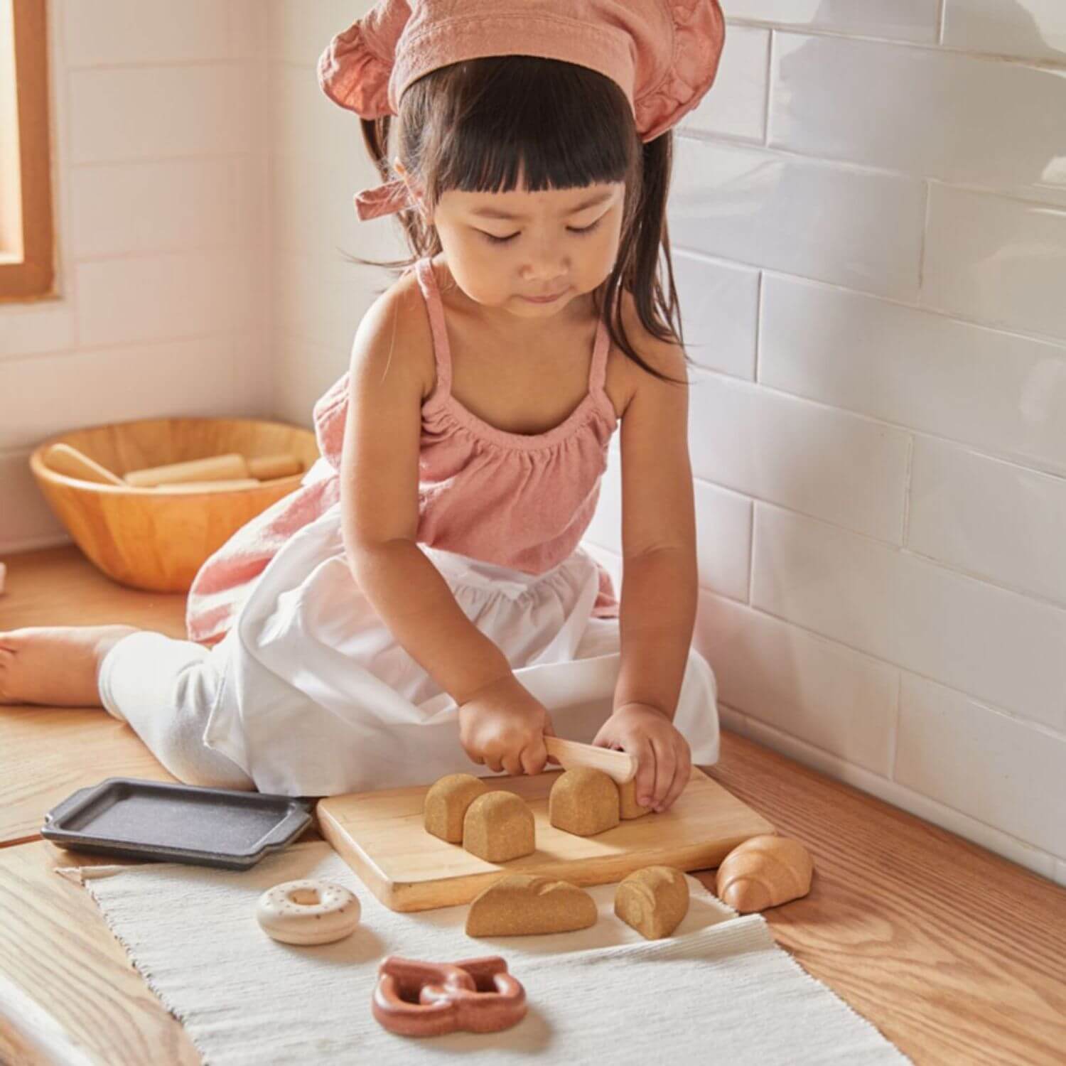 Girl Playing PlanToys Bread Set