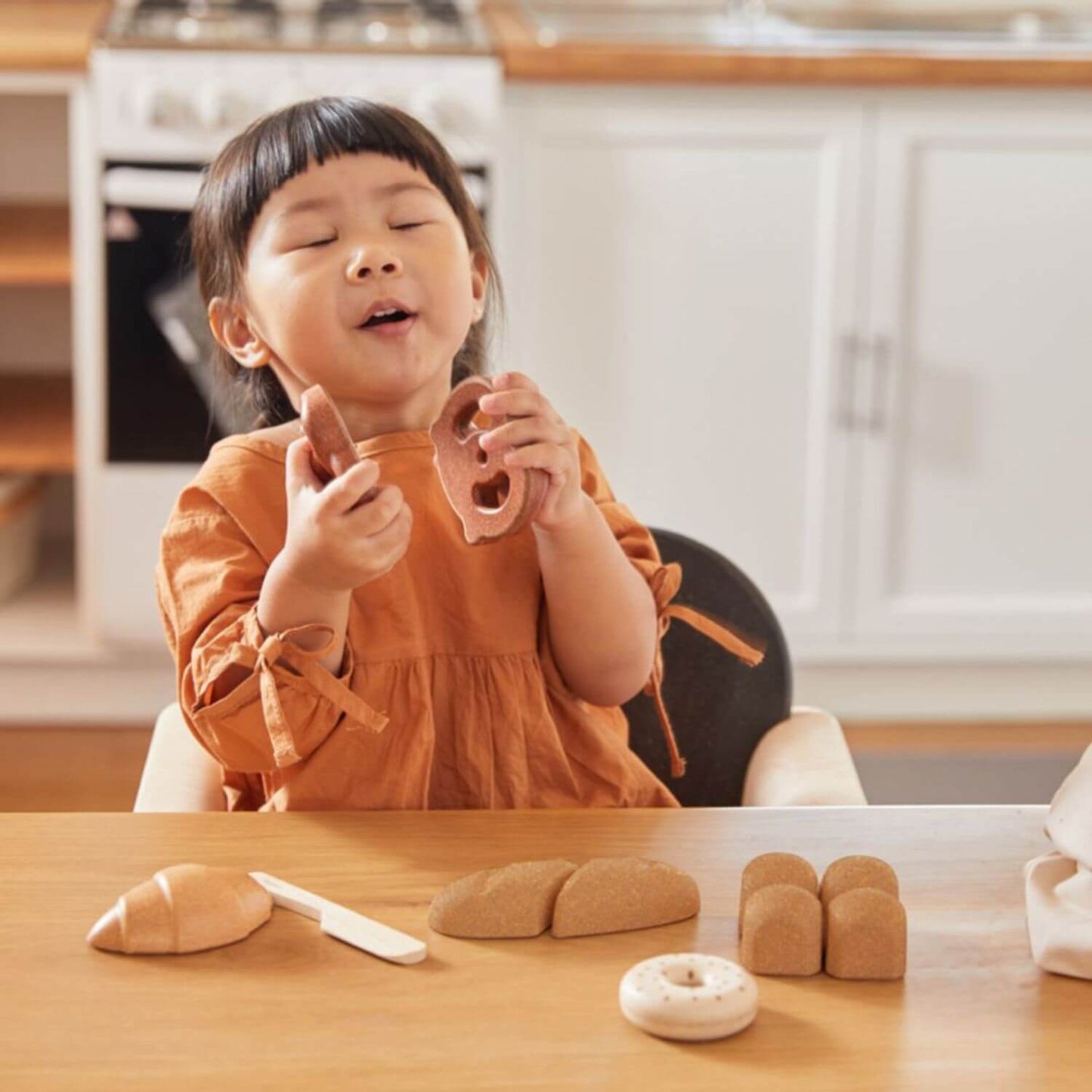 Girl Playing PlanToys Bread Set