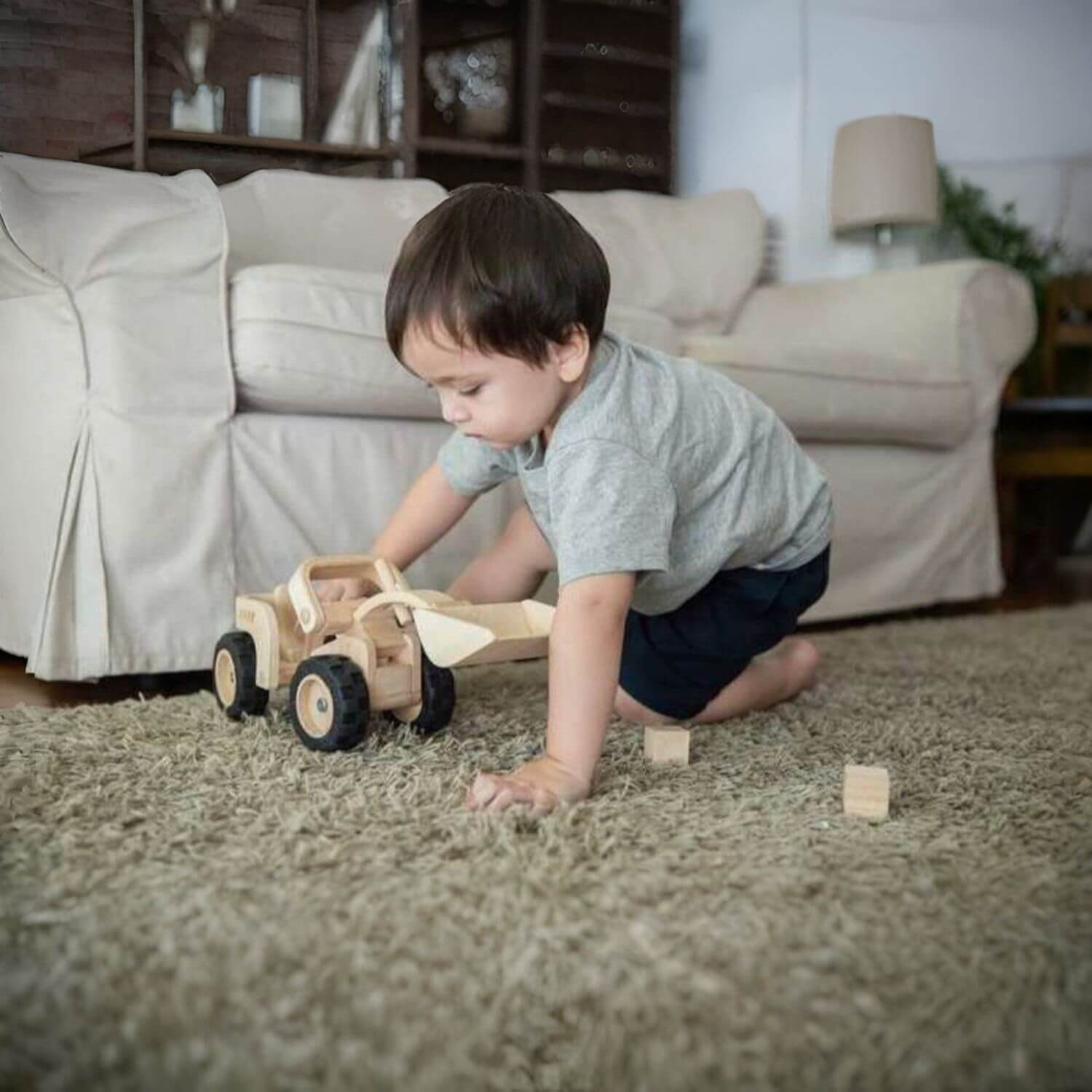 Boy Playing PlanToys Bulldozer