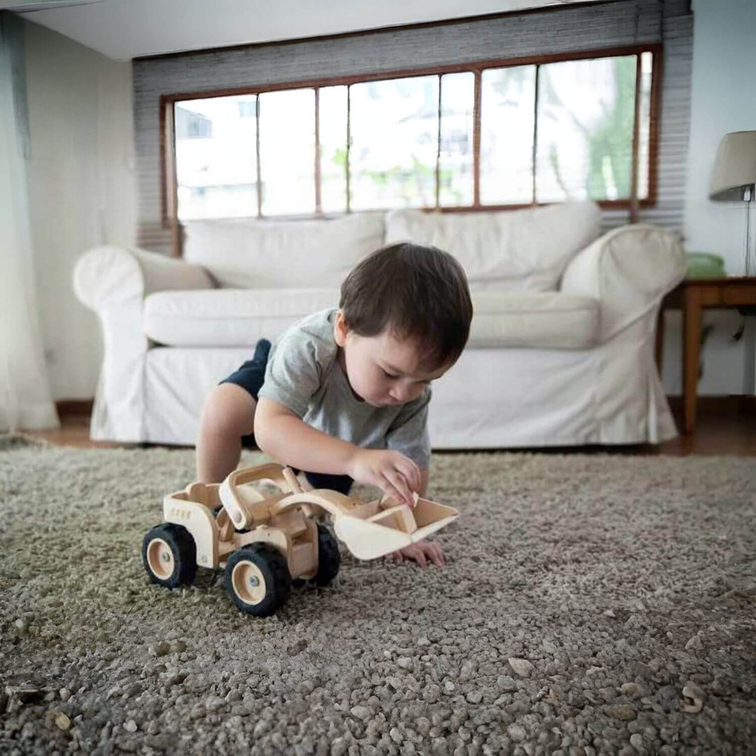 Boy Playing PlanToys Bulldozer