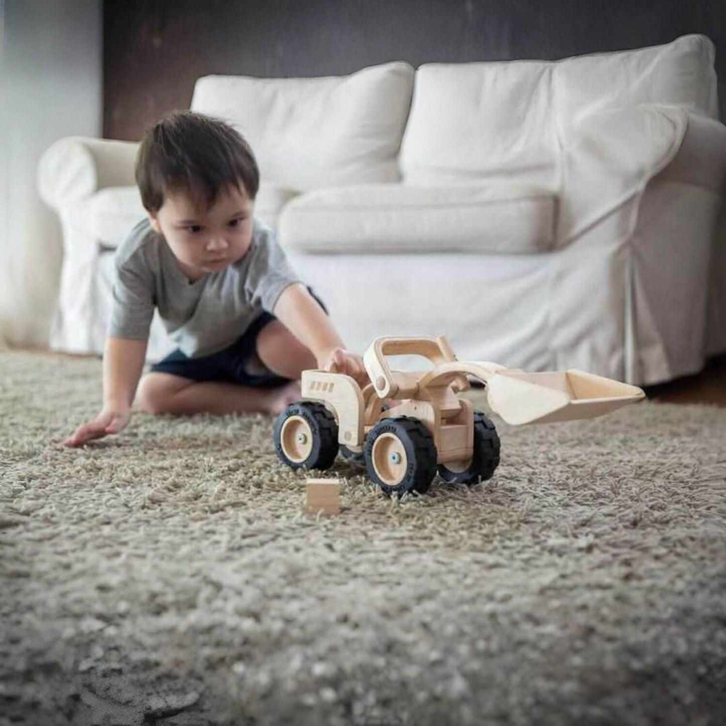 Boy Playing PlanToys Bulldozer