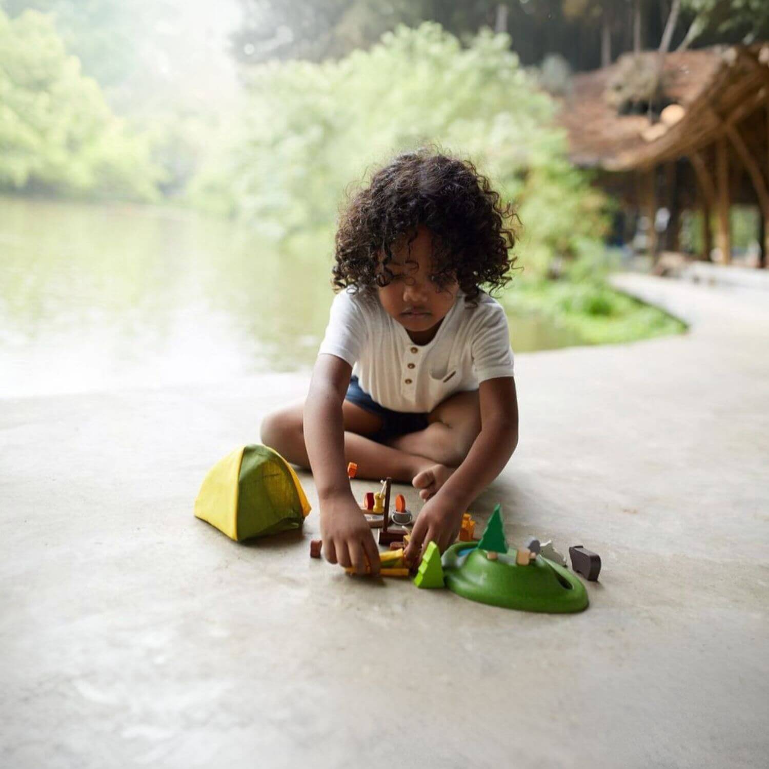 Boy Playing PlanToys Camping Set