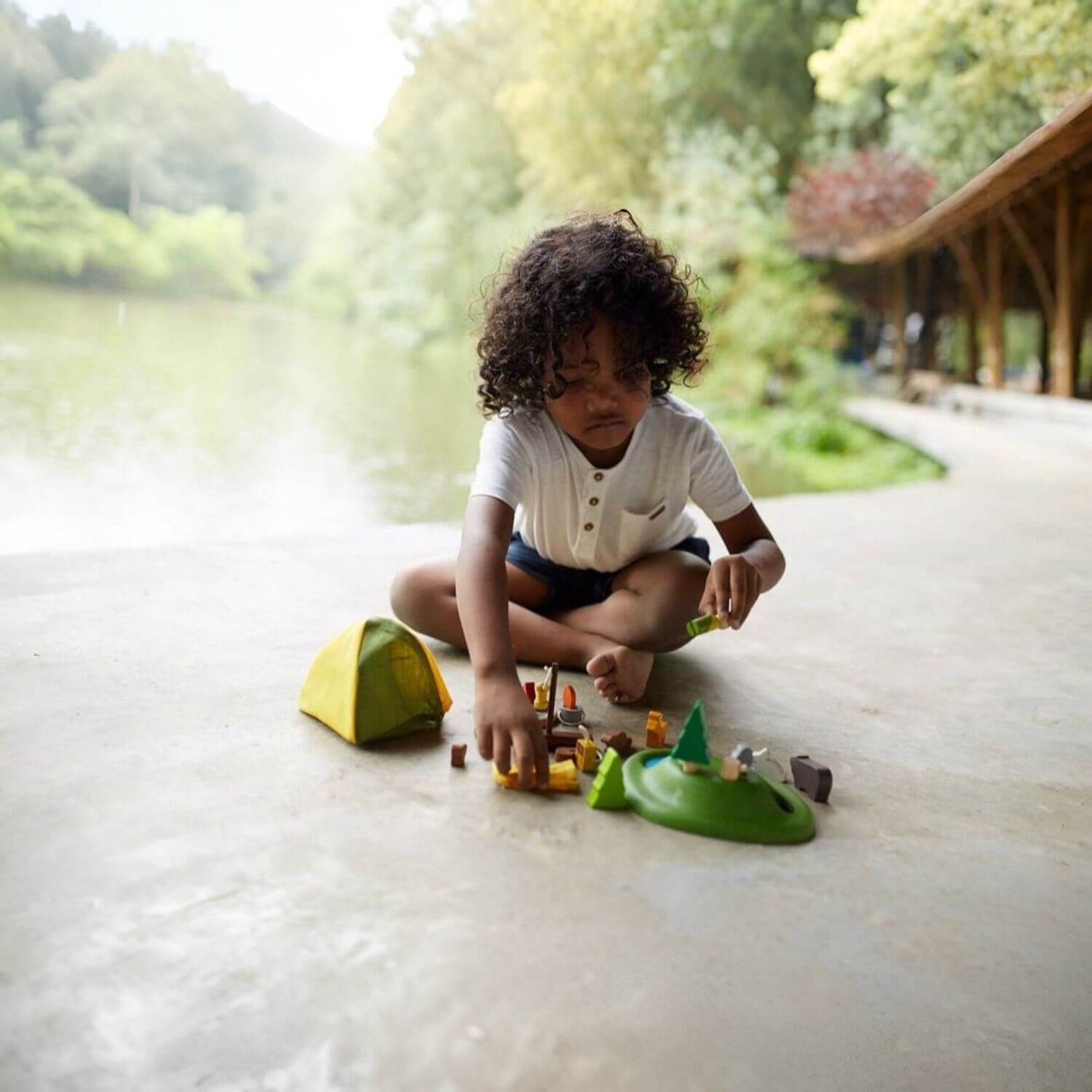 Boy Playing PlanToys Camping Set