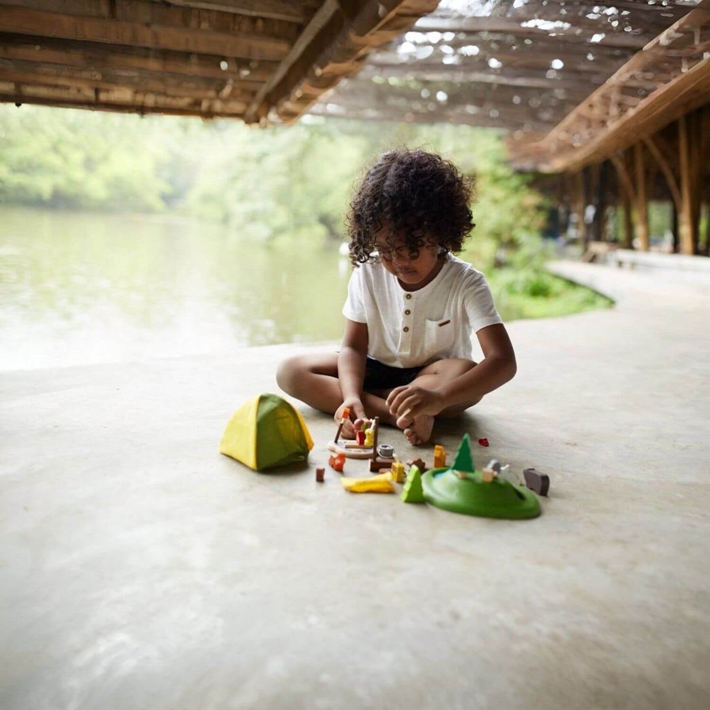 Boy Playing PlanToys Camping Set