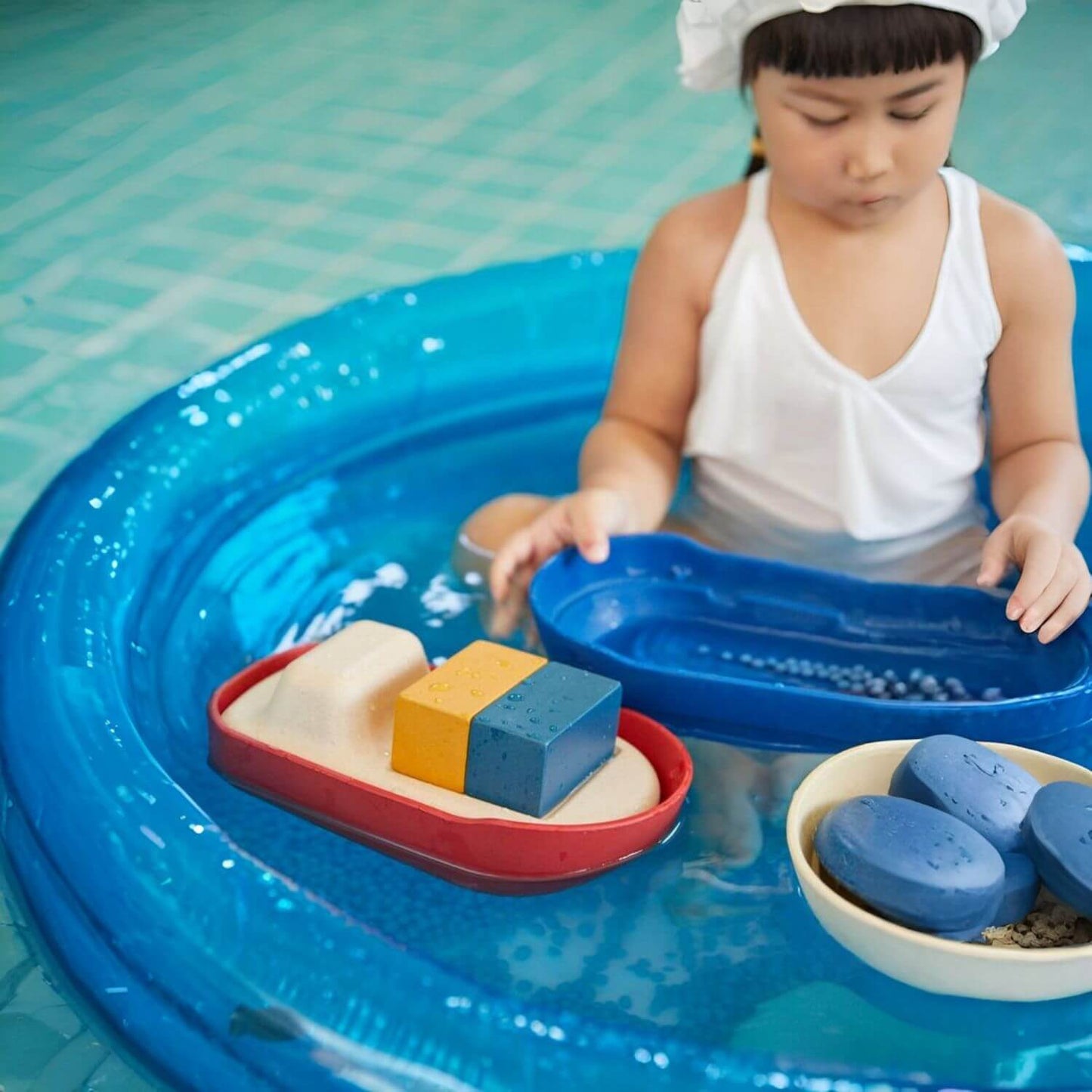 Girl Playing PlanToys Cargo Ship