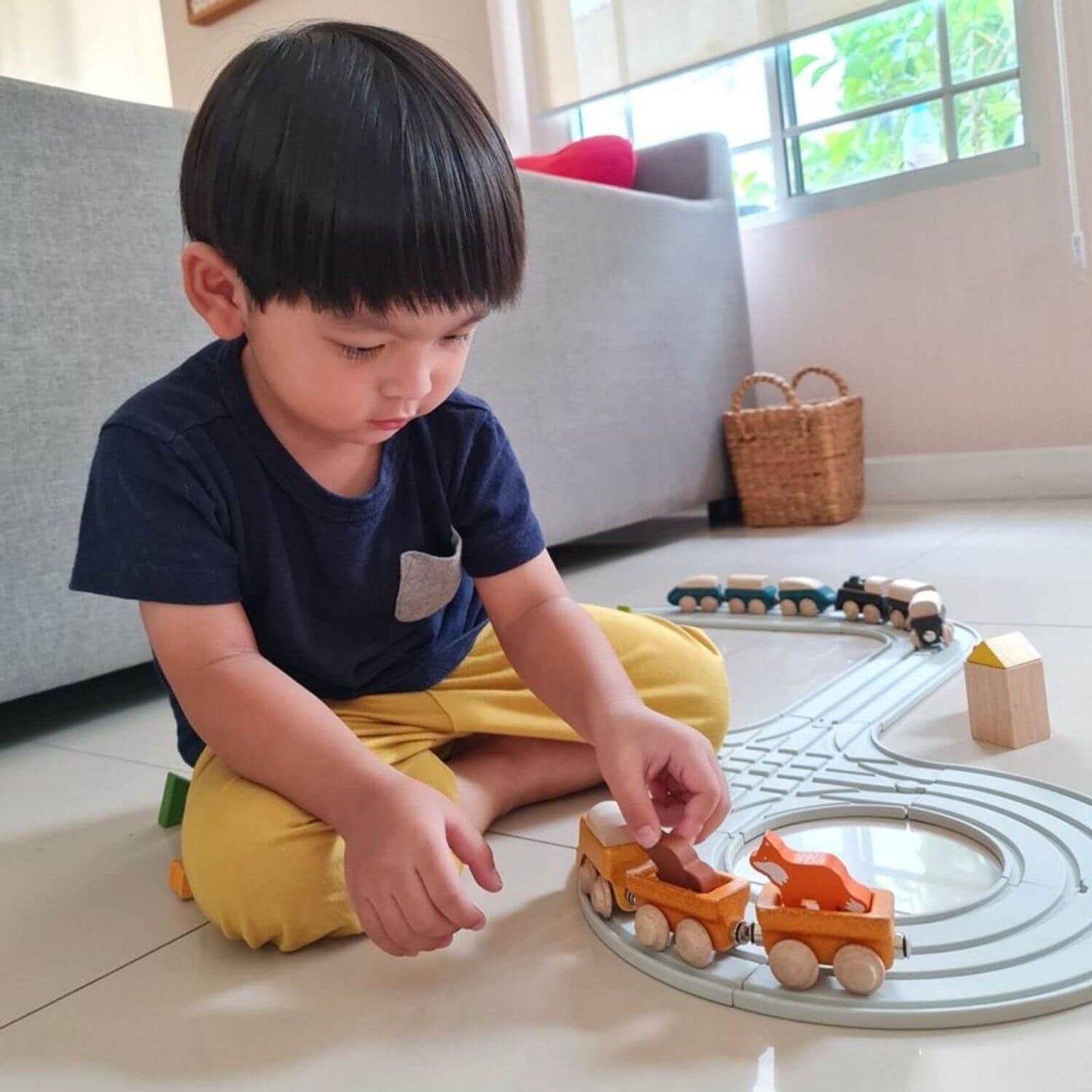 Boy Playing PlanToys Cargo Train