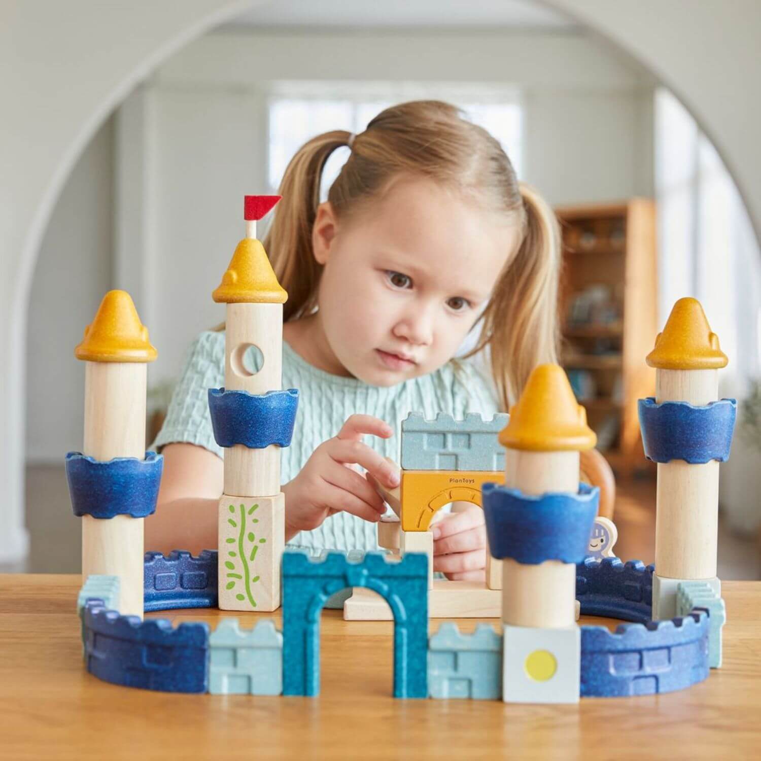 Girl Playing PlanToys Castle Blocks