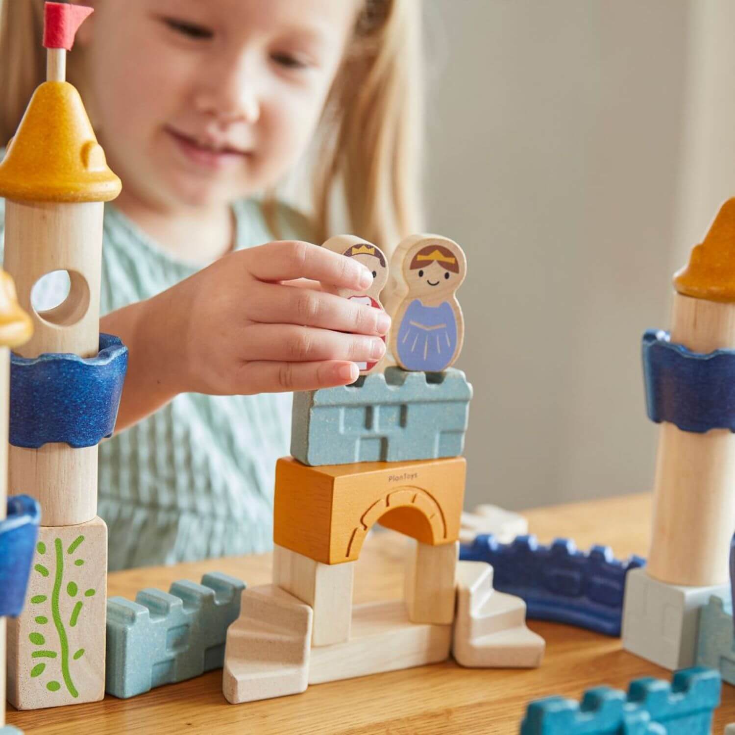 Girl Playing PlanToys Castle Blocks