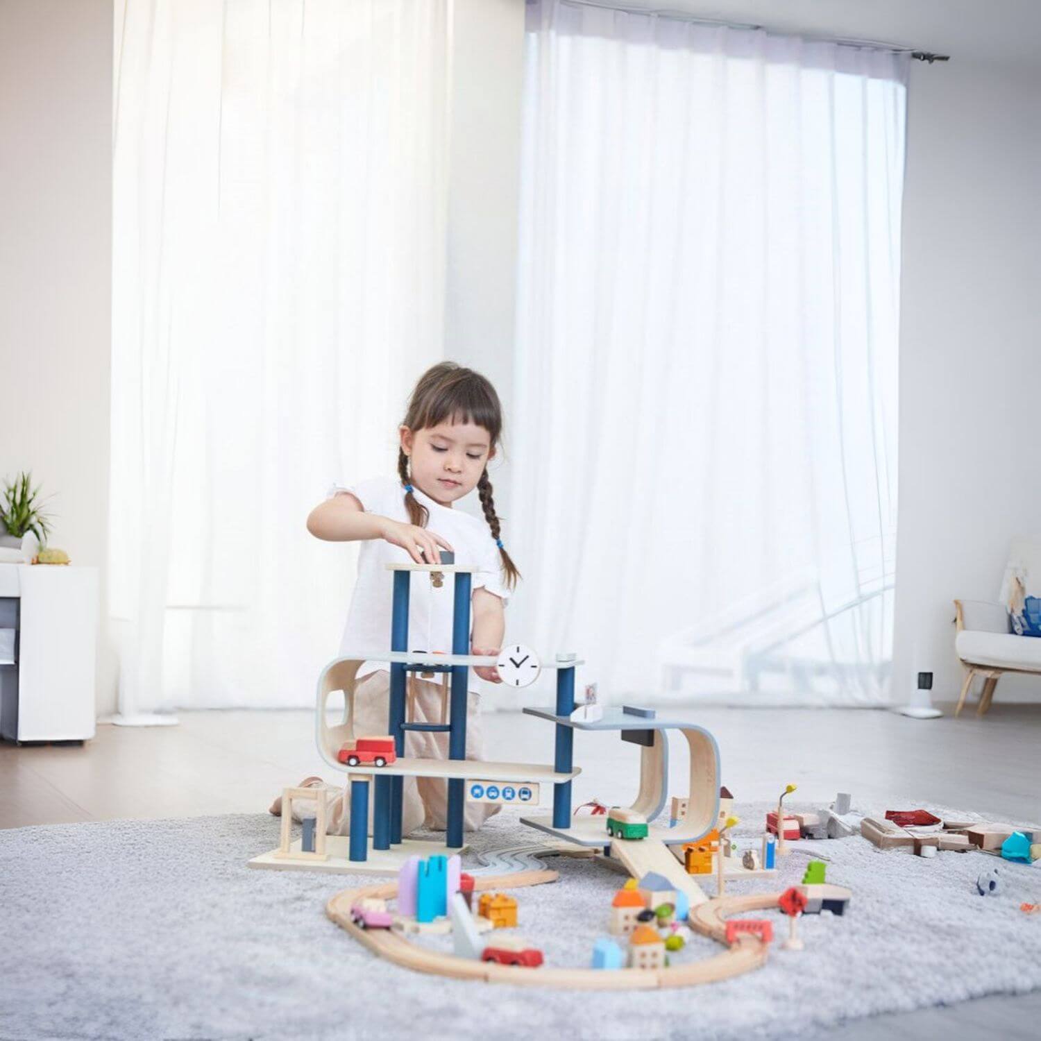 Girl Playing PlanToys Central Station