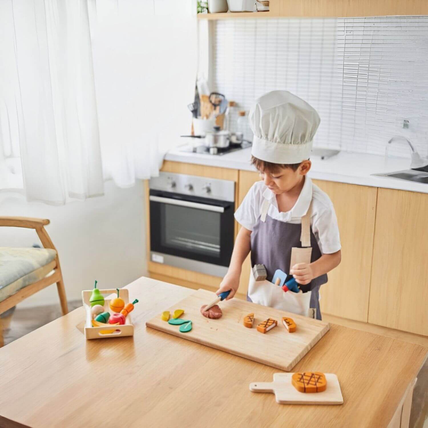 Boy Wearing PlanToys Chef Set to Cook