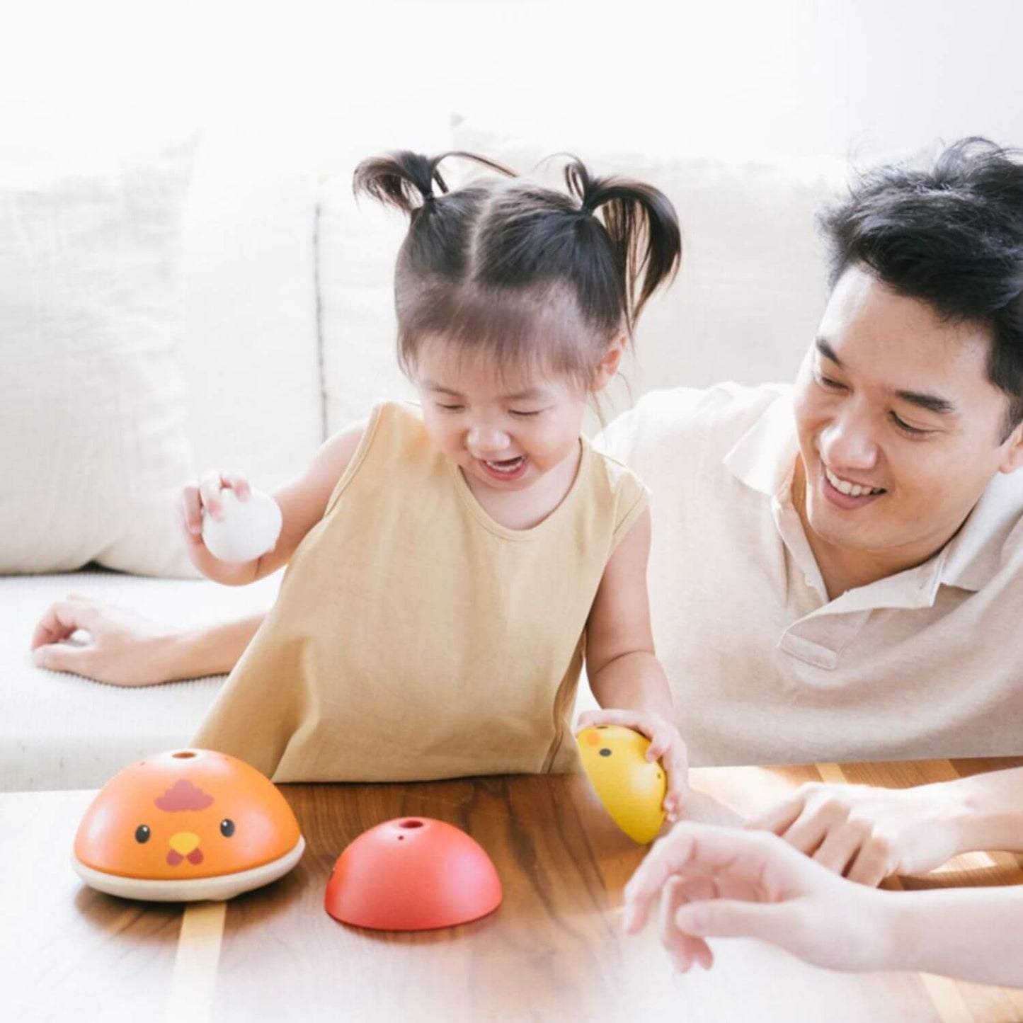 Dad & Girl Playing PlanToys Chicken Nesting