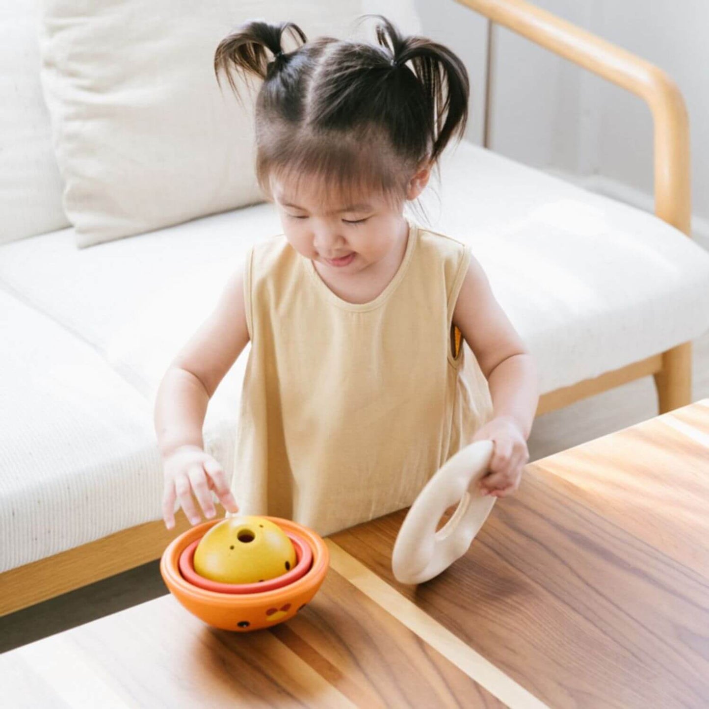 Girl Playing PlanToys Chicken Nesting